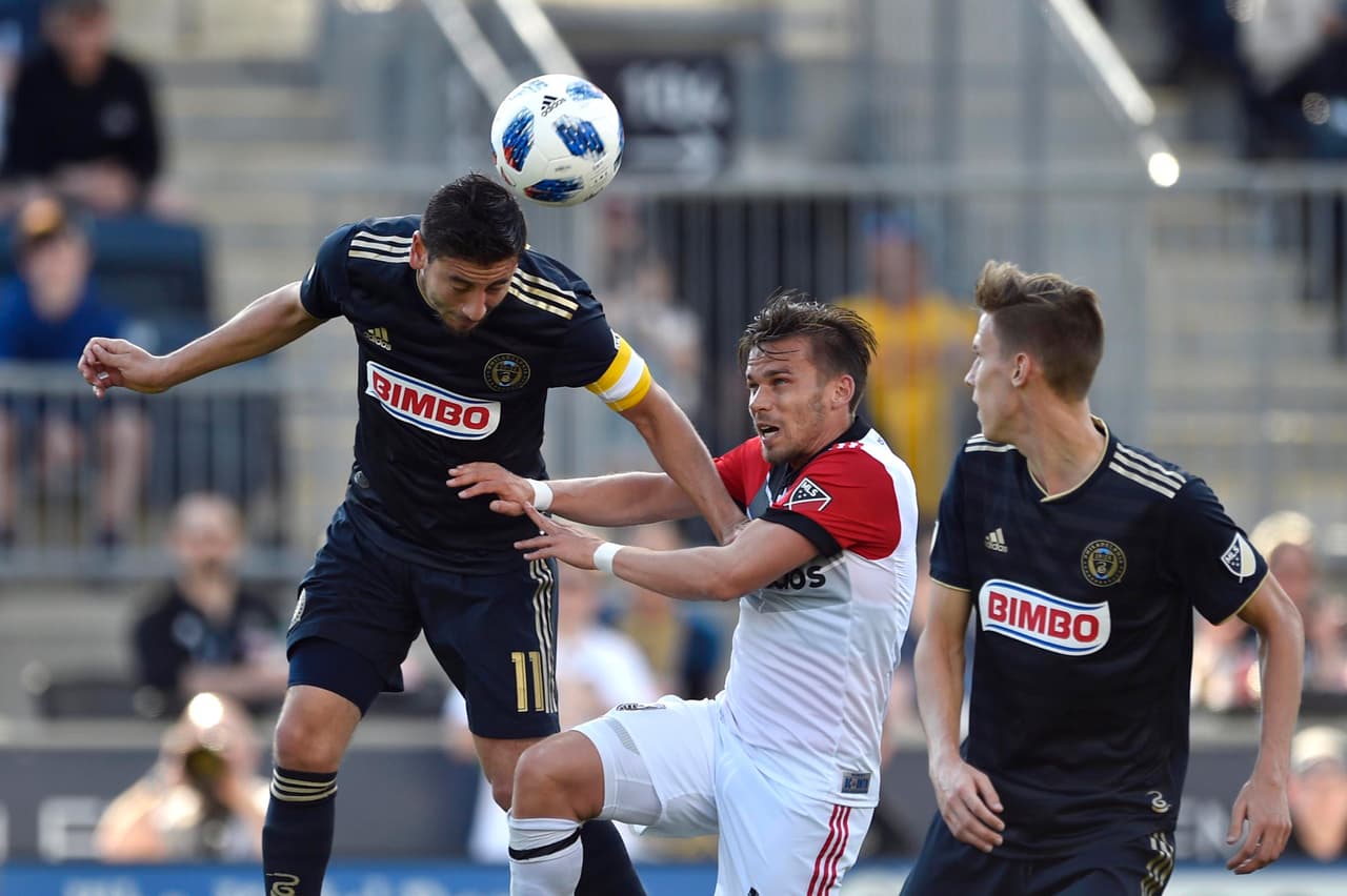 Apr 28, 2018; Philadelphia, PA, USA; Philadelphia Union midfielder Alejandro Bedoya (11) heads the ball past D.C. United midfielder Zoltan Stieber (18) during the second half at Talen Energy Stadium. Mandatory Credit: Derik Hamilton-USA TODAY Sports