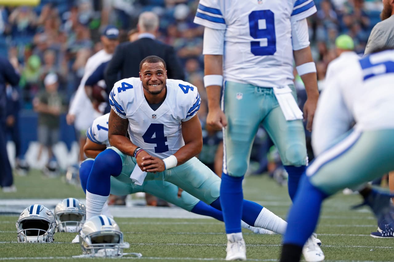 Dallas Cowboys quarterback Dak Prescott (4) has proved to be a quick understudy behind quarterback Tony Romo (9) during an NFL preseason game against the Seattle Seahawks on Thursday, August 25, 2016, in Seattle, Wa. The Seahawks won the game, 27-17. (Greg Trott via AP)