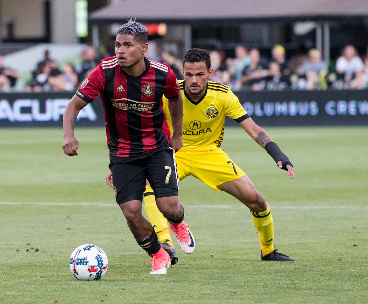 Jul 1, 2017; Columbus, OH, USA; Atlanta United forward Josef Martinez (7) advances the ball ahead of Columbus Crew SC midfielder Artur (7) at MAPFRE Stadium. Mandatory Credit: Greg Bartram-USA TODAY Sports