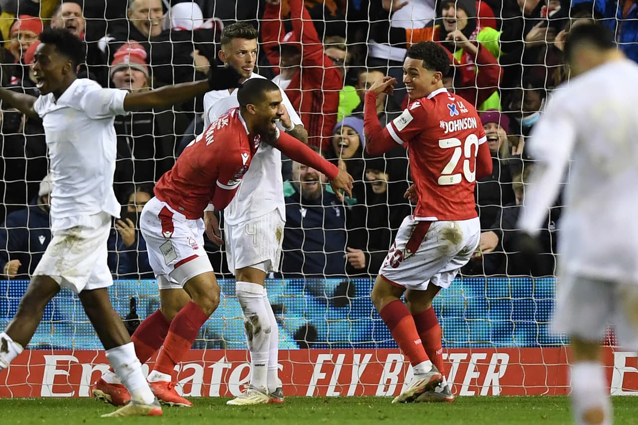 Nottingham Forest's English striker Lewis Grabban (2nd L) celebrates after scoring the opening goal during the English FA Cup third round football match between Nottingham Forest and Arsenal at The City Ground in Nottingham, central England, on January 9, 2022. - - RESTRICTED TO EDITORIAL USE. No use with unauthorized audio, video, data, fixture lists, club/league logos or 'live' services. Online in-match use limited to 120 images. An additional 40 images may be used in extra time. No video emulation. Social media in-match use limited to 120 images. An additional 40 images may be used in extra time. No use in betting publications, games or single club/league/player publications. (Photo by Daniel LEAL / AFP) / RESTRICTED TO EDITORIAL USE. No use with unauthorized audio, video, data, fixture lists, club/league logos or 'live' services. Online in-match use limited to 120 images. An additional 40 images may be used in extra time. No video emulation. Social media in-match use limited to 120 images. An additional 40 images may be used in extra time. No use in betting publications, games or single club/league/player publications. / RESTRICTED TO EDITORIAL USE. No use with unauthorized audio, video, data, fixture lists, club/league logos or 'live' services. Online in-match use limited to 120 images. An additional 40 images may be used in extra time. No video emulation. Social media in-match use limited to 120 images. An additional 40 images may be used in extra time. No use in betting publications, games or single club/league/player publications. (Photo by DANIEL LEAL/AFP via Getty Images)