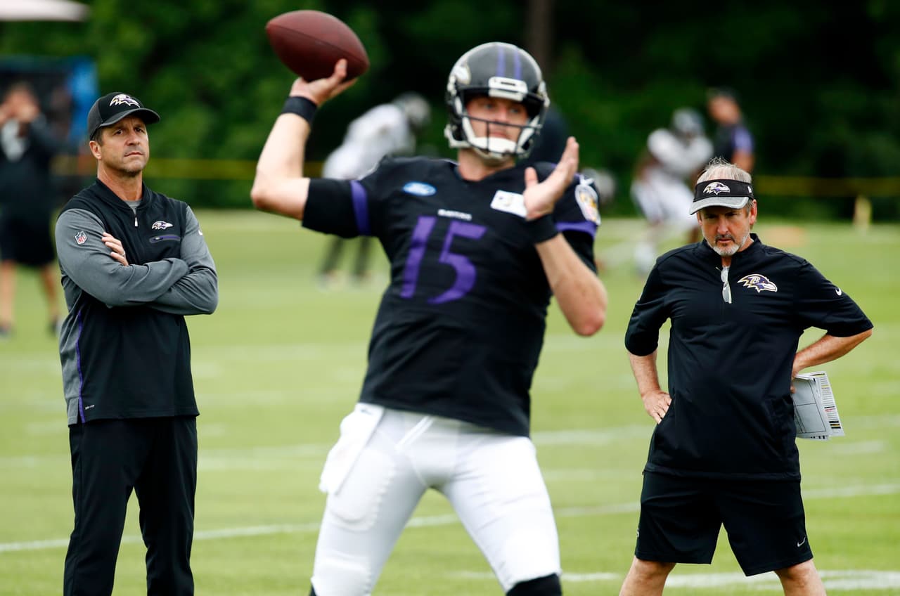 FILE - In this July 29, 2017, file photo, Baltimore Ravens head coach John Harbaugh, left, and senior offensive assistant Craig Ver Steeg, right, watch quarterback Ryan Mallett throw a pass during an NFL football training camp practice in Owings Mills, Md. It’s been a week since Ravens coach Harbaugh floated the idea of adding Colin Kaepernick, a veteran who has Super Bowl experience and the baggage that comes from his decision last year to literally sit out the National Anthem on game day. The topic came up because Joe Flacco, the team’s starter for the past nine seasons, came to training camp with a bad back. And Mallett has not performed well in practice. (AP Photo/Patrick Semansky, File)