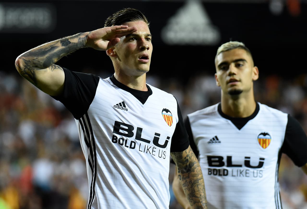 Valencia's forward Santi Mina (L) celebrates after scoring a goal during the Spanish league football match Valencia CF vs Sevilla FC at the Mestalla stadium in Valencia on October 21, 2017. / AFP PHOTO / JOSE JORDAN (Photo credit should read JOSE JORDAN/AFP/Getty Images)
