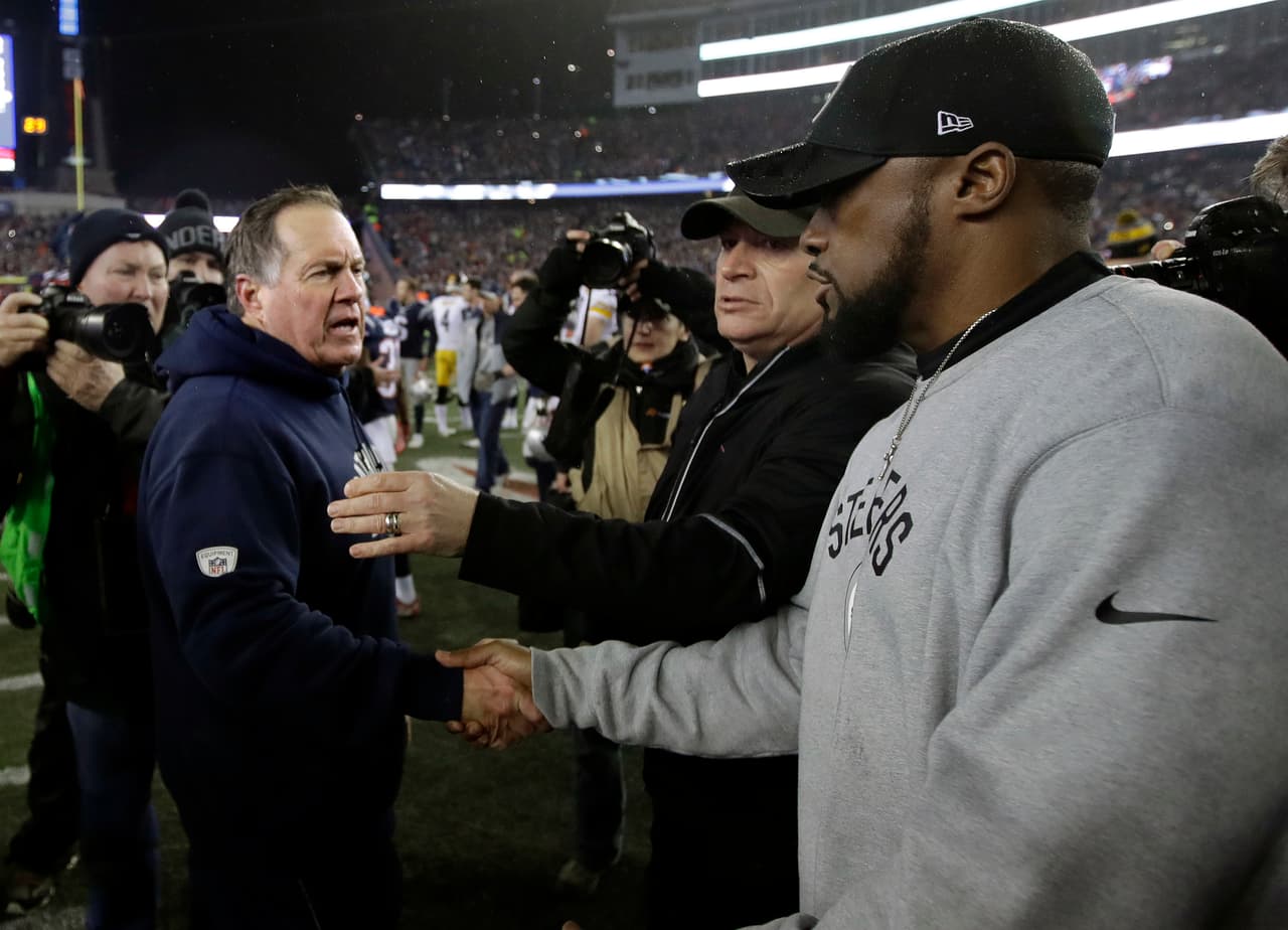 New England Patriots head coach Bill Belichick, left, speaks to Pittsburgh Steelers head coach Mike Tomlin at midfield after the AFC championship NFL football game, Sunday, Jan. 22, 2017, in Foxborough, Mass. The Patriots won 36-17 to advance to the Super Bowl. (AP Photo/Charles Krupa)