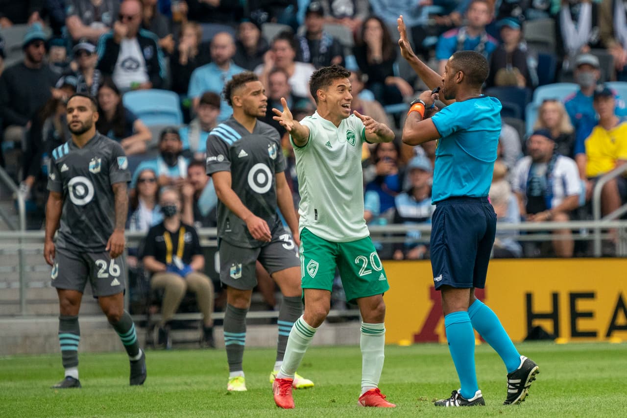 Oct 10, 2021; Saint Paul, Minnesota, USA; Colorado Rapids forward Nicolas Mezquida (20) continues to plead his case for a penalty kick with the official as Minnesota United midfielder Hassani Dotson (31) and defender D.J. Taylor (26) look on the second half on at Allianz Field. Mandatory Credit: Matt Blewett-USA TODAY Sports
