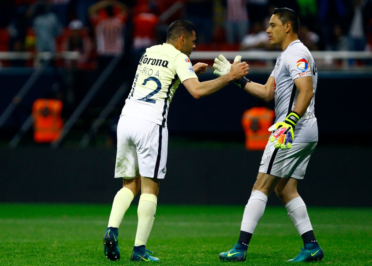 Pablo Aguilar (R) and Moises Munoz of America celebrate after winning the Mexican Apertura 2016 tournament quarterfinal football match against Guadalajara at Chivas stadium on November 27, 2016, in Guadalajara, Mexico. / AFP / Hector GUERRERO (Photo credit should read HECTOR GUERRERO/AFP/Getty Images)