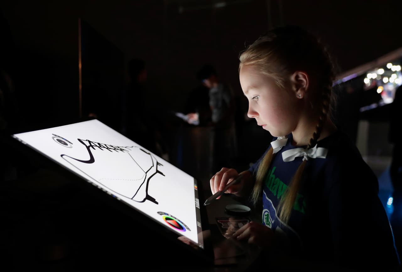 HOUSTON, TX - JANUARY 29: Fans draw custom designed football uniforms on Microsoft Surface Pro screens at the NFL Experience on January 29, 2017 in Houston, Texas. (Photo by Tim Warner/Getty Images)