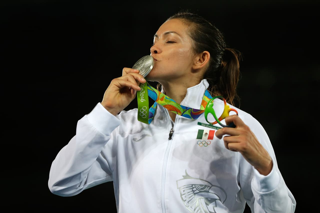 RIO DE JANEIRO, BRAZIL - AUGUST 20: Silver medalist Maria del Rosario Espinoza Espinoza of Mexico celebrates on the podium during the medal ceremony for the Taekwondo Women +67kg Gold Medal Contest on Day 15 of the Rio 2016 Olympic Games at Carioca Arena 3 on August 20, 2016 in Rio de Janeiro, Brazil. (Photo by Jamie Squire/Getty Images)
