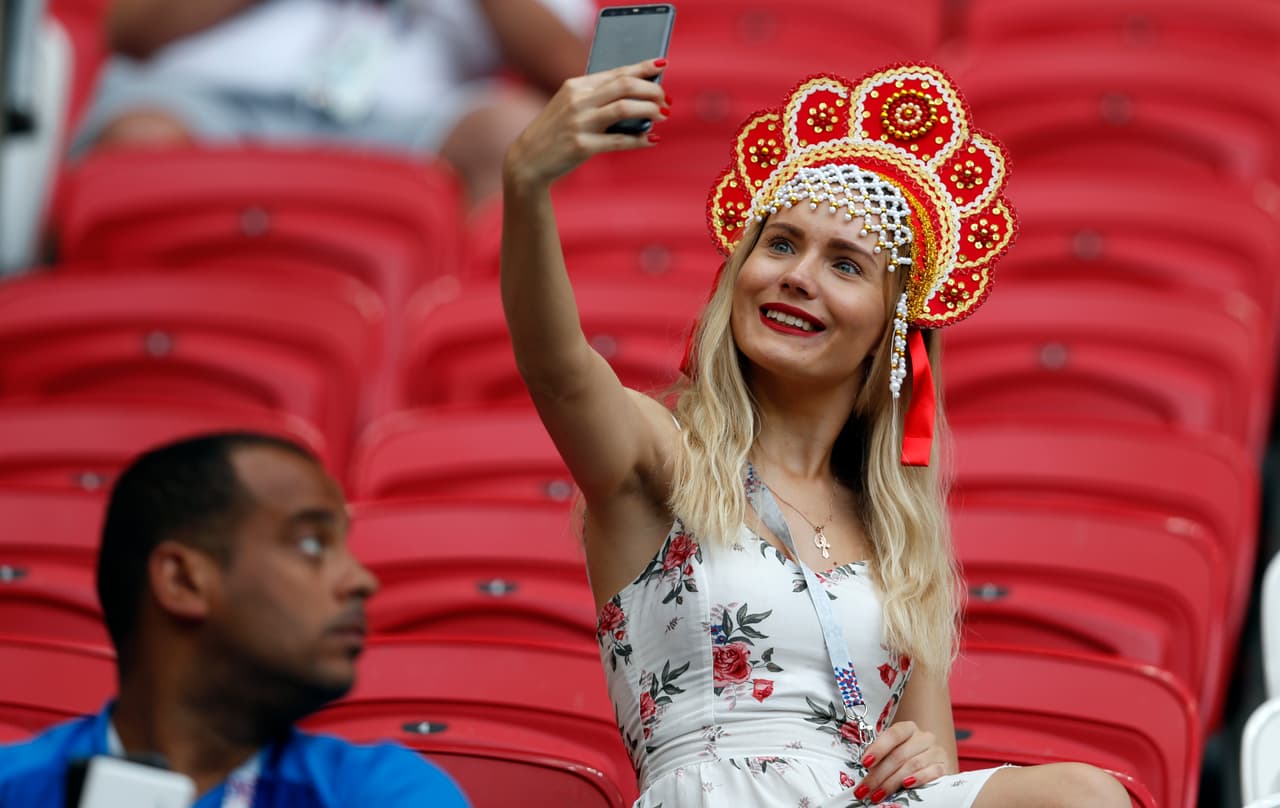 A supporter takes a selfie as she waits for the start of the quarterfinal match between Brazil and Belgium at the 2018 soccer World Cup in the Kazan Arena, in Kazan, Russia, Friday, July 6, 2018. (AP Photo/Eduardo Verdugo)