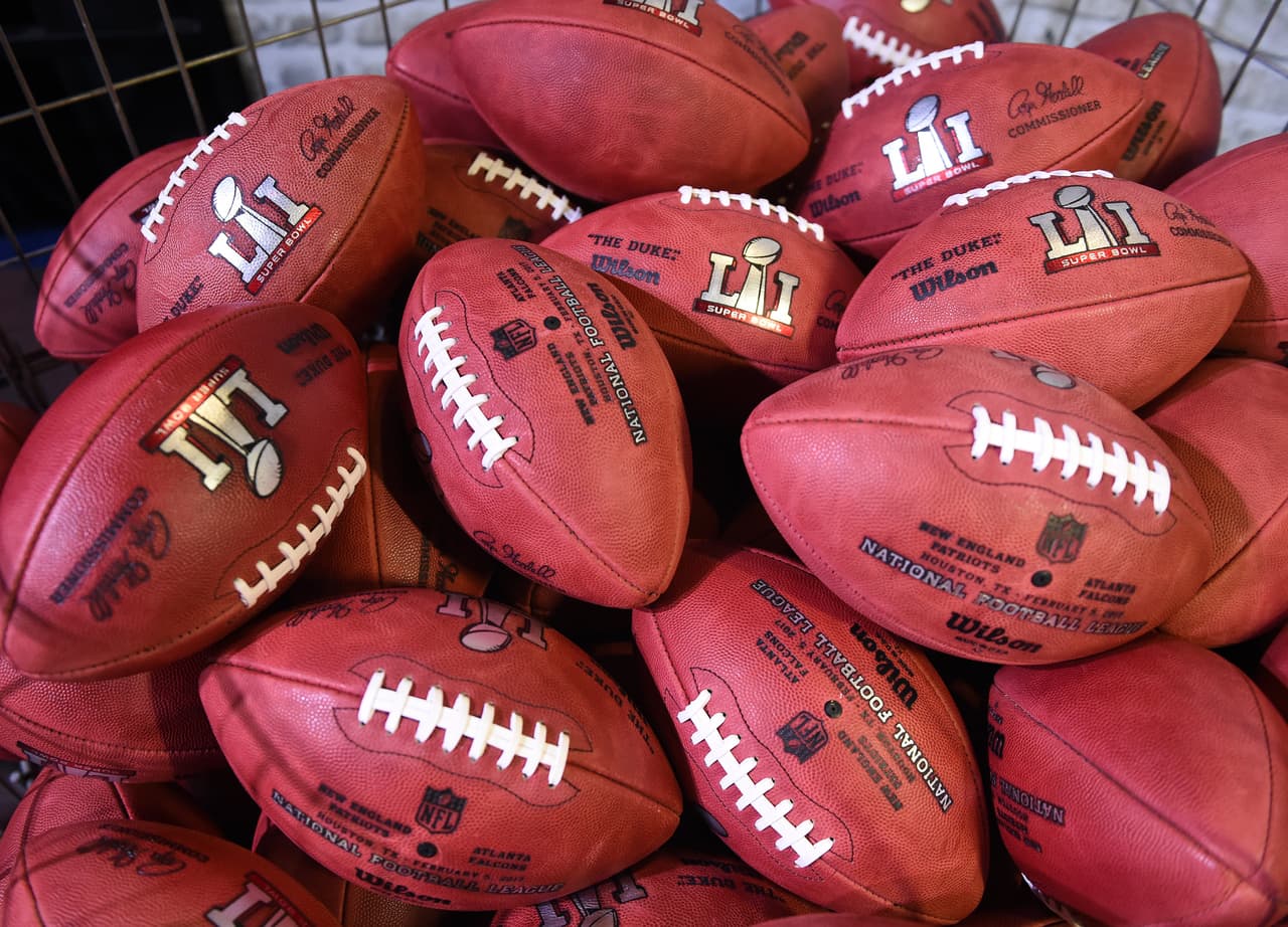Wilson NFL footballs like the ones that will used at the Super Bowl are seen at the NFL Experience at the George R. Brown Convention Center February 3, 2017 in Houston, Texas two days before the New England Patriots play the Atlanta Falcons in Super Bowl 51. / AFP / TIMOTHY A. CLARY (Photo credit should read TIMOTHY A. CLARY/AFP/Getty Images)