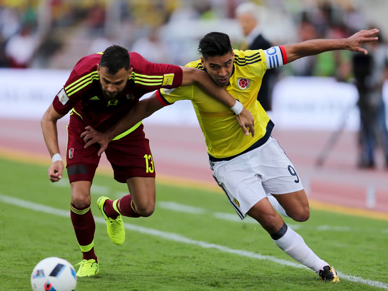 Colombia's Radamel Falcao Garcia, right, and Venezuela's Jhon Chancellor vie for the ball during their 2018 Russia World Cup qualifying soccer match in San Cristobal, Venezuela, Thursday, Aug. 31, 2017. (AP Photo/Fernando Llano)
