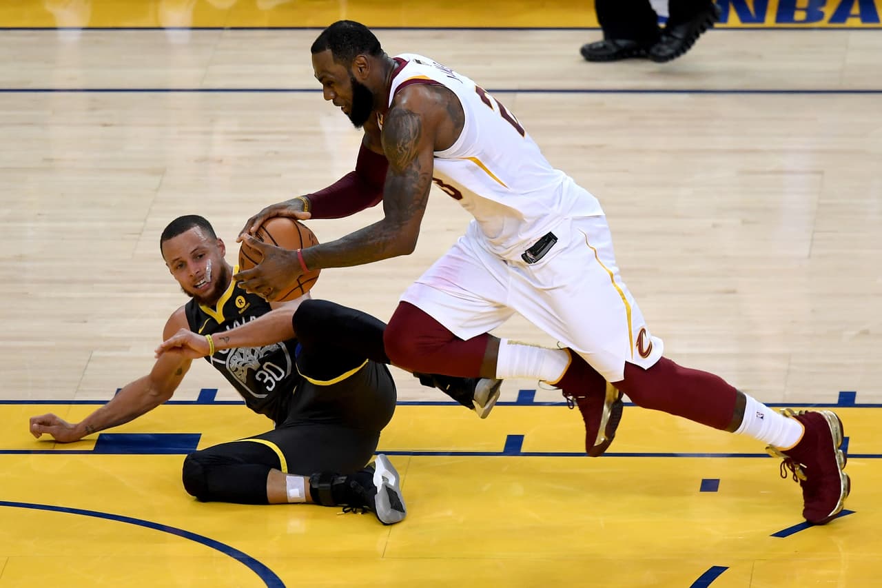 OAKLAND, CA - JUNE 03: LeBron James #23 of the Cleveland Cavaliers collides with Stephen Curry #30 of the Golden State Warriors during the third quarter in Game 2 of the 2018 NBA Finals at ORACLE Arena on June 3, 2018 in Oakland, California. NOTE TO USER: User expressly acknowledges and agrees that, by downloading and or using this photograph, User is consenting to the terms and conditions of the Getty Images License Agreement. (Photo by Thearon W. Henderson/Getty Images)