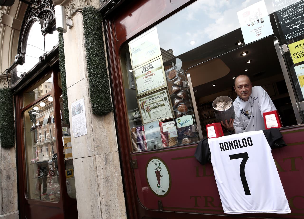 Mister Leonardo, from Miretti's ice-cream shop in downtown Turin, poses with the new ice-cream taste called CR7 and created for Cristiano Ronaldo's arrival at Juventus football club on July 14, 2018. - This ice-cream is made with Ginja Lisboa, a typical portuguese sour cherry liqueur, and chocolate's flakes. (Photo by Isabella Bonotto / AFP) (Photo credit should read ISABELLA BONOTTO/AFP/Getty Images)