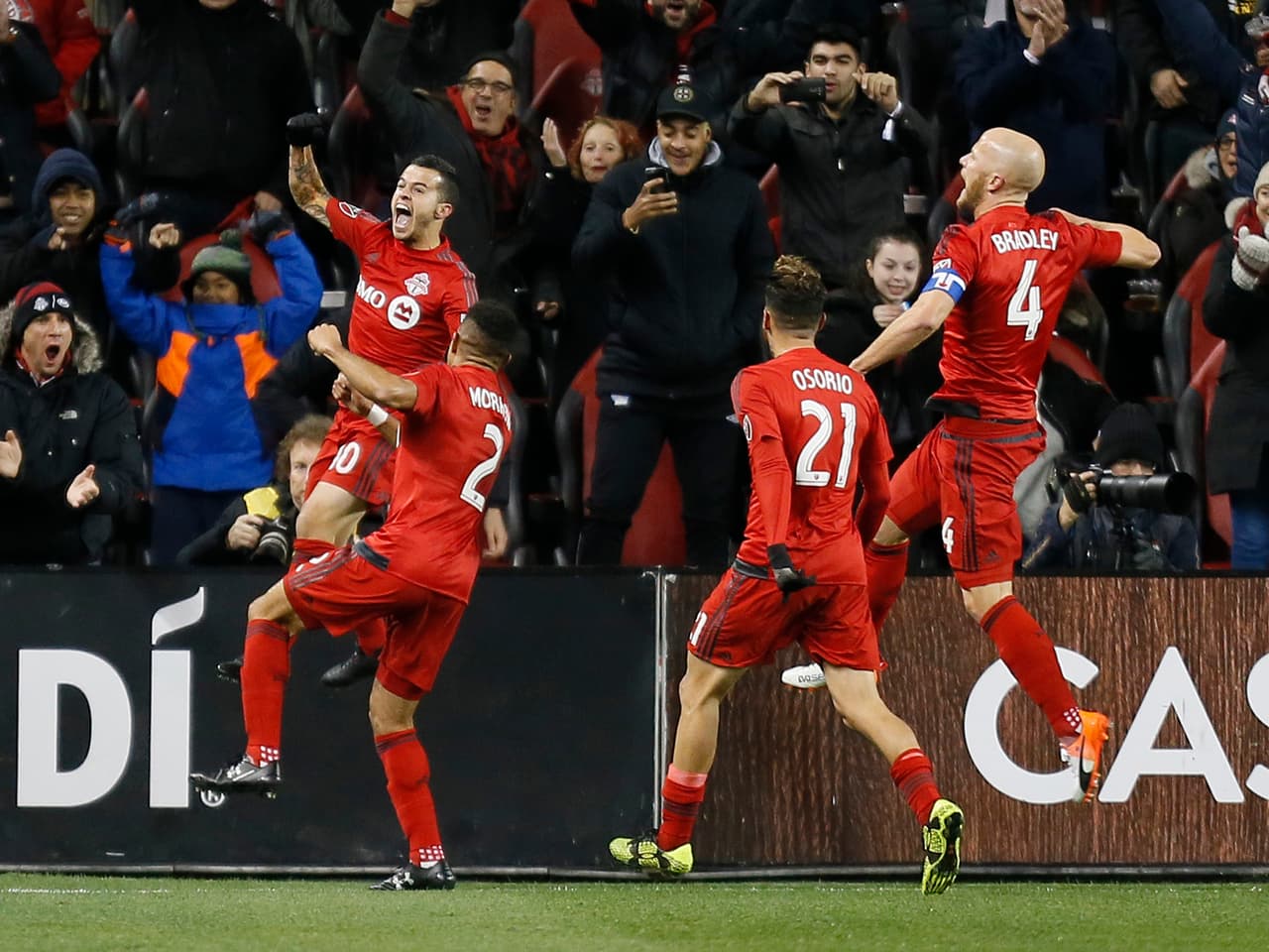 Oct 26, 2016; Toronto, CANADA; Toronto FC defender Justin Morrow (2) and midfielder Jonathan Osorio (21) and midfielder Michael Bradley (4) celebrate a goal by forward Sebastian Giovinco (left) during the first half against the Philadelphia Union at BMO Field. Mandatory Credit: John E. Sokolowski-USA TODAY Sports