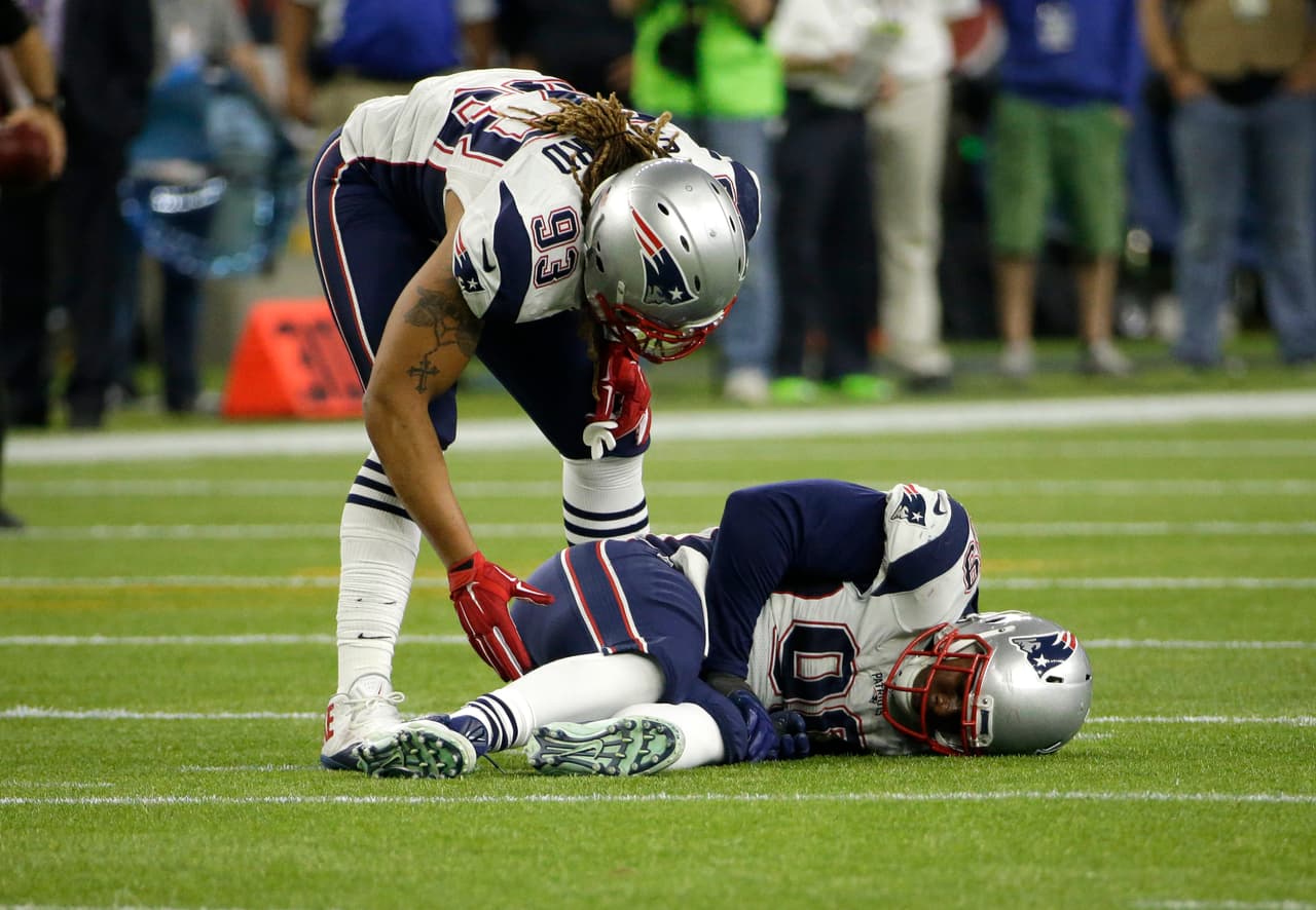 New England Patriots' Jabaal Sheard (93) checks on Dominique Easley, bottom after Easley suffered an unknown injury during the second half of an NFL football game against the Houston Texans on Sunday, Dec. 13, 2015, in Houston. (AP Photo/David J. Phillip)