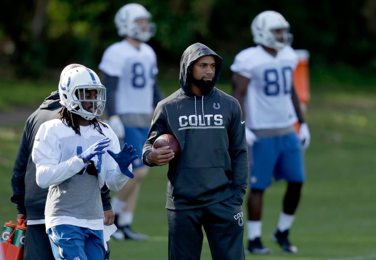 Indianapolis Colts injured wide receiver Donte Moncrief, second right, watches as receiver T. Y. Hilton, left, takes part in an NFL training session at the Grove Hotel in Chandler's Cross, England, Friday, Sept. 30, 2016. The Indianapolis Colts are due to play the Jacksonville Jaguars at Wembley stadium in London on Sunday in a regular season NFL game. (AP Photo/Matt Dunham)
