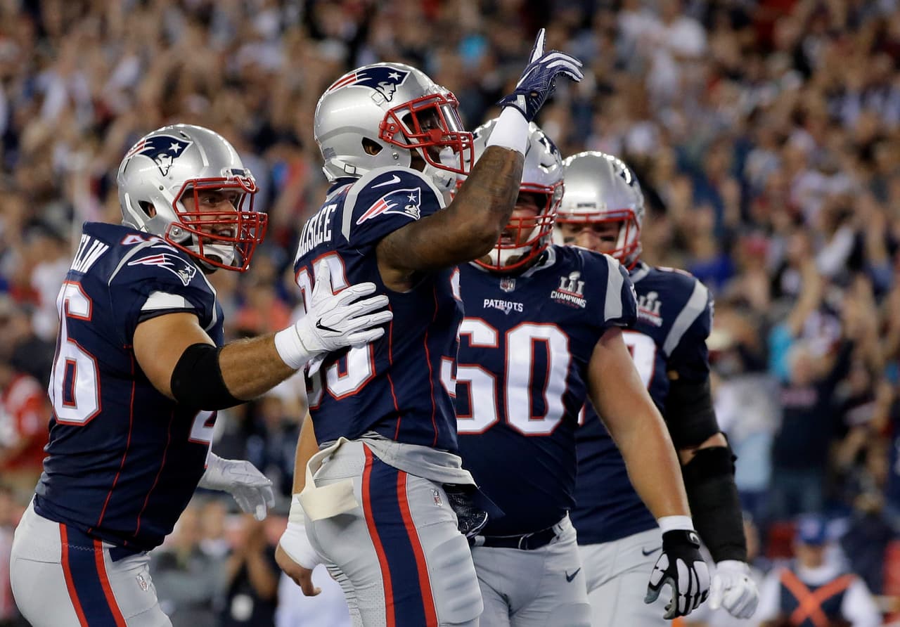 New England Patriots running back Mike Gillislee, center, celebrates his touchdown against the Kansas City Chiefs during the first half of an NFL football game, Thursday, Sept. 7, 2017, in Foxborough, Mass. (AP Photo/Steven Senne)