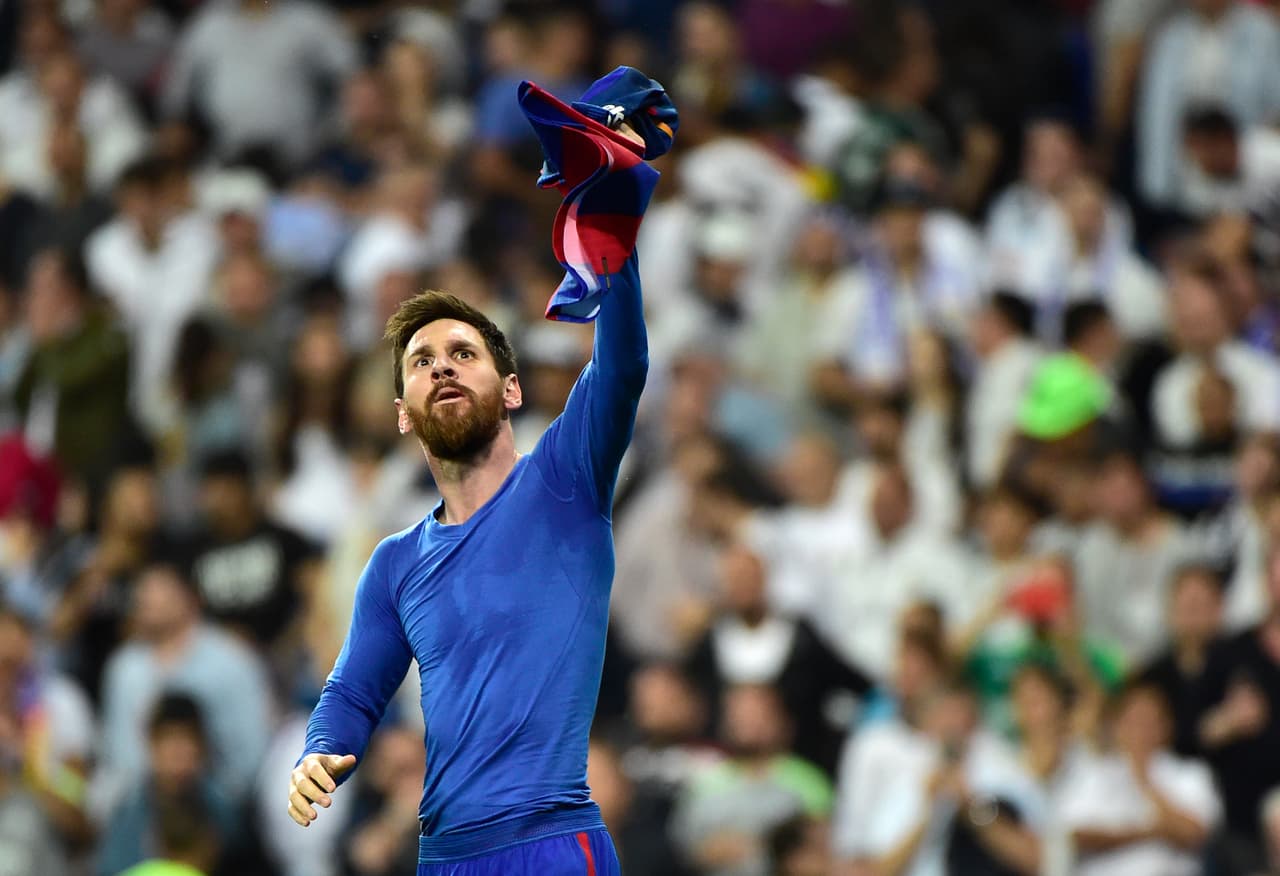 Barcelona's Argentinian forward Lionel Messi celebrates a goal during the Spanish league football match Real Madrid CF vs FC Barcelona at the Santiago Bernabeu stadium in Madrid on April 23, 2017. / AFP PHOTO / GERARD JULIEN (Photo credit should read GERARD JULIEN/AFP/Getty Images)