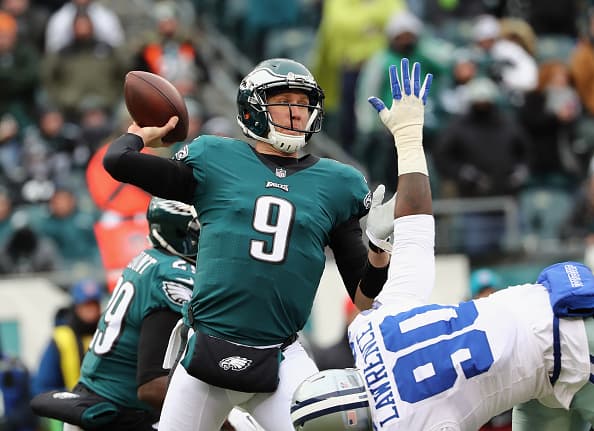 PHILADELPHIA, PA - DECEMBER 31: Quarterback Nick Foles #9 of the Philadelphia Eagles looks ot pass against defensive end Demarcus Lawrence #90 of the Dallas Cowboys during the first quarter of the game at Lincoln Financial Field on December 31, 2017 in Philadelphia, Pennsylvania. (Photo by Elsa/Getty Images)