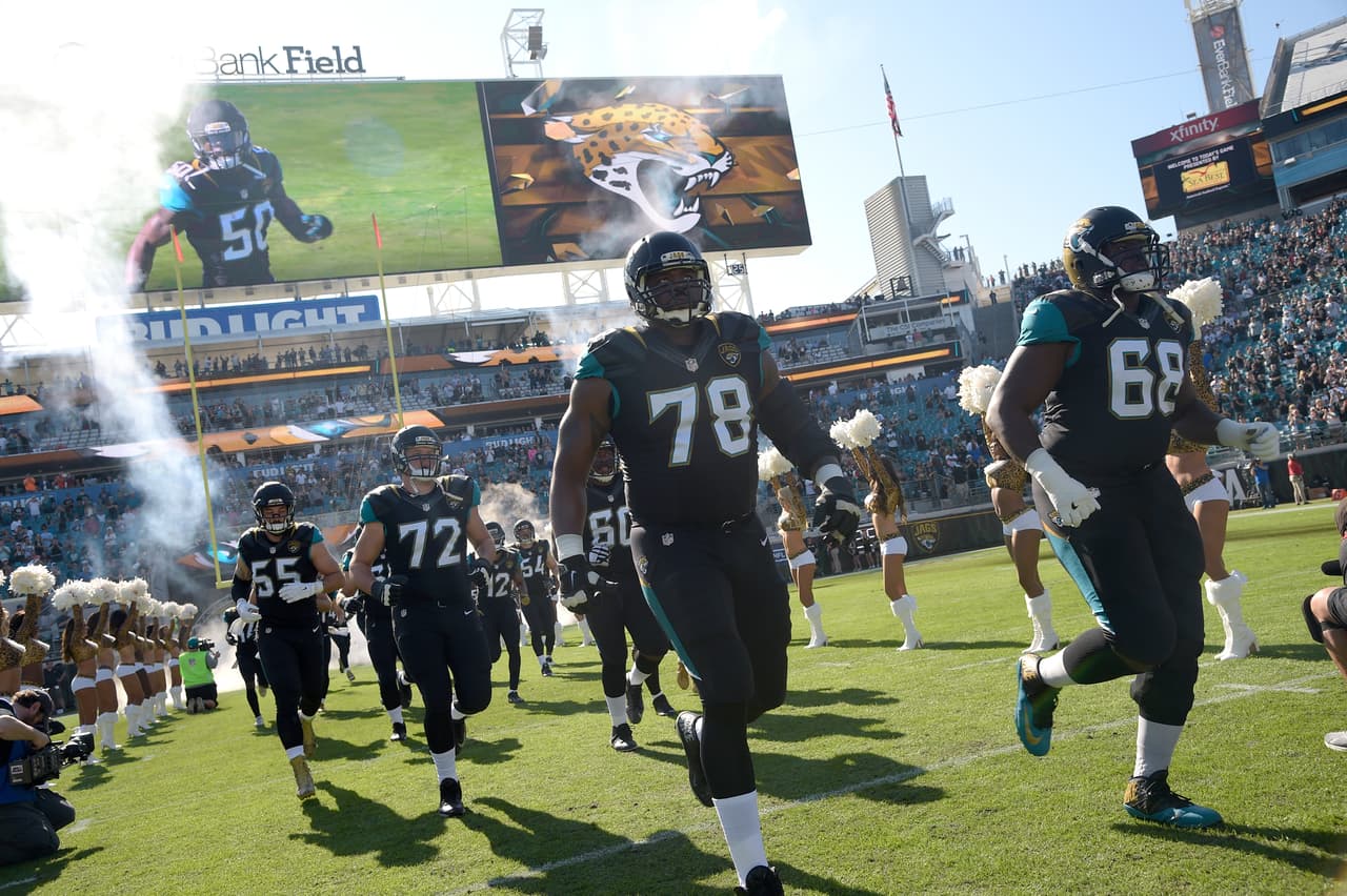 Jacksonville Jaguars offensive tackle Jermey Parnell (78) and tackle Kelvin Beachum (68) run onto the field during player introductions before an NFL football game against the Tennessee Titans in Jacksonville, Fla., Saturday, Dec. 24, 2016. (AP Photo/Phelan M. Ebenhack)