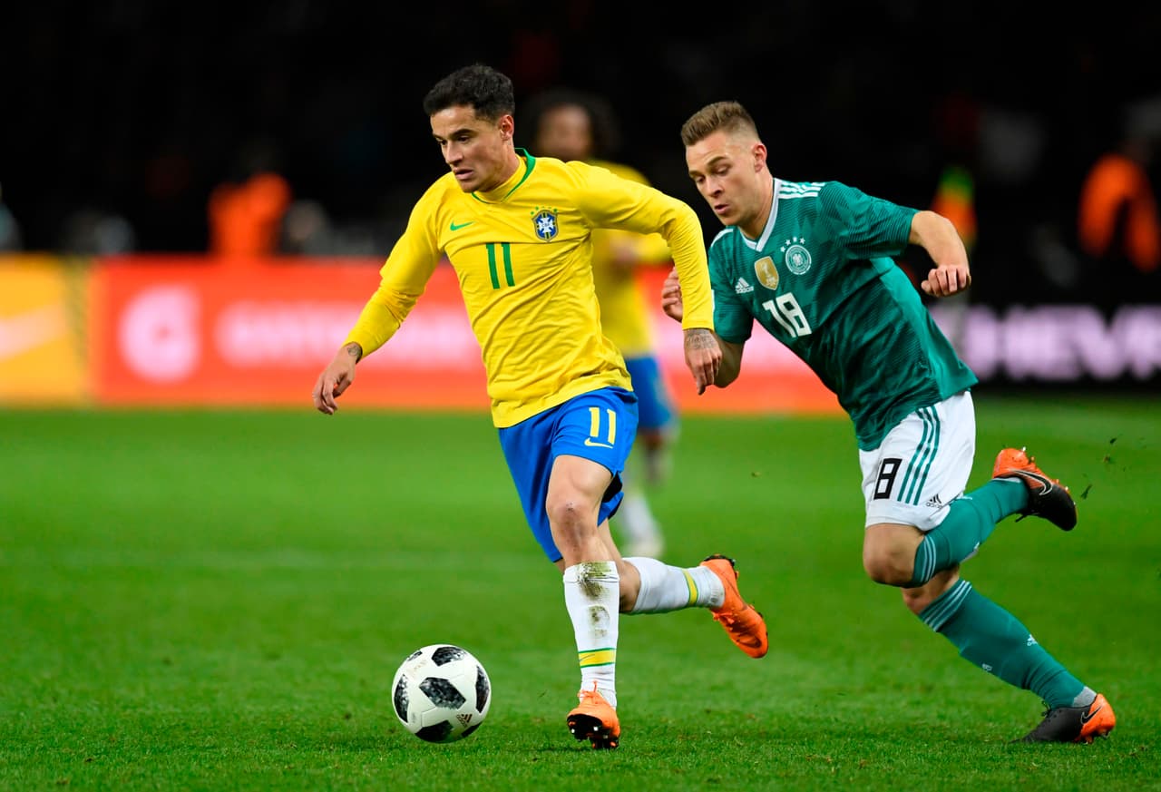 Brazil's midfielder Philippe Coutinho (L) and Germany's midfielder Joshua Kimmich vie for the ball during the international friendly football match between Germany and Brazil in Berlin, on March 27, 2018. / AFP PHOTO / ROBERT MICHAEL (Photo credit should read ROBERT MICHAEL/AFP/Getty Images)