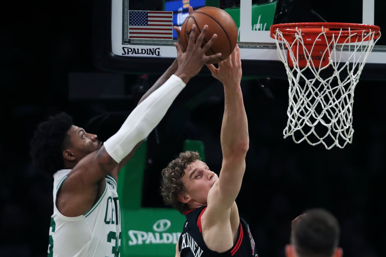 El rebote es para Marcus Smart de los Boston Celtics, pese al intento de Lauri Markkanen por quedarse con el esférico.