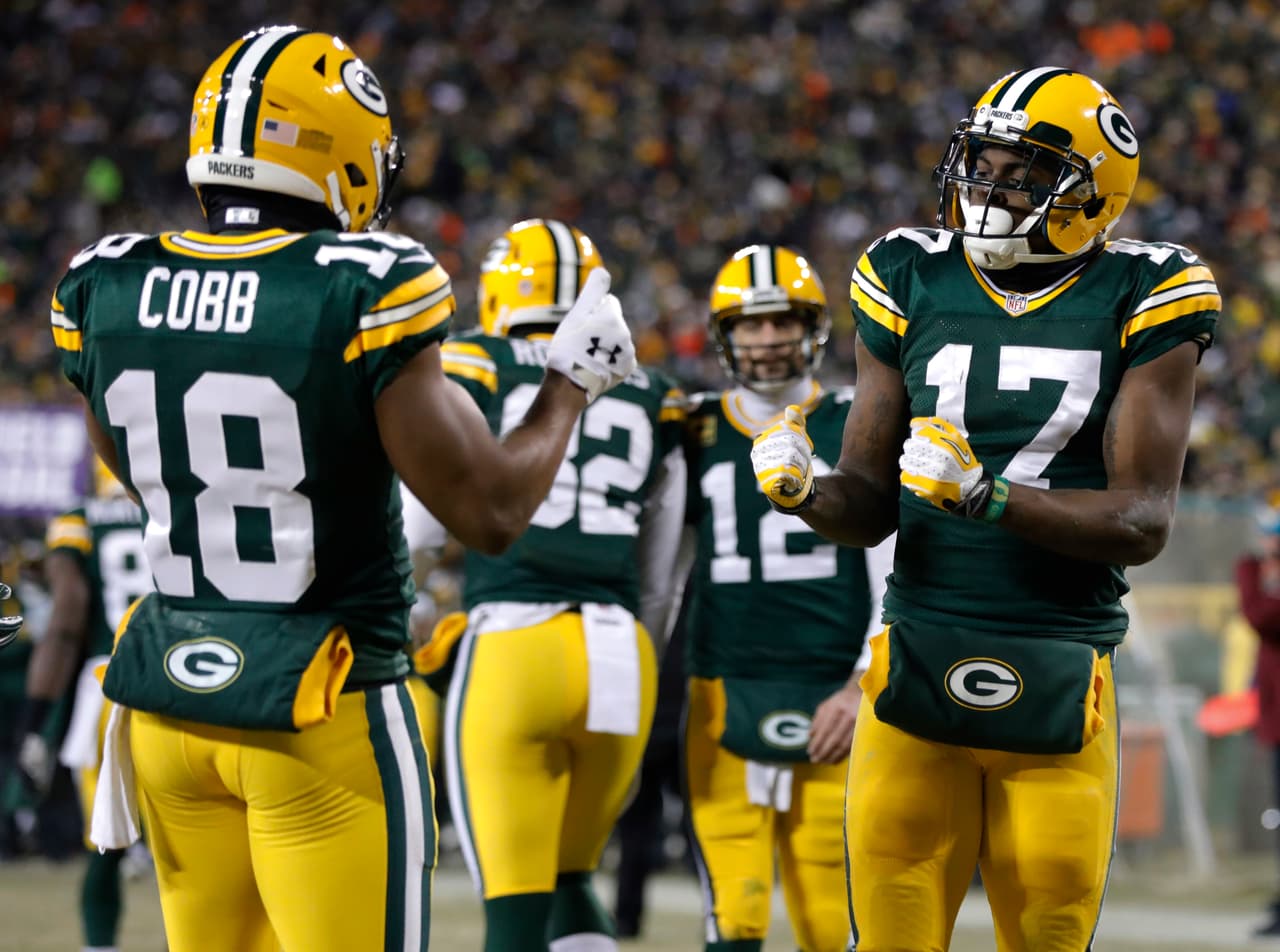 Green Bay Packers wide receiver Davante Adams (17) celebrates with wide receiver Randall Cobb (18) after making a touchdown reception during the first half of an NFC wild-card NFL football game against the New York Giants, Sunday, Jan. 8, 2017, in Green Bay, Wis. (AP Photo/Mike Roemer)