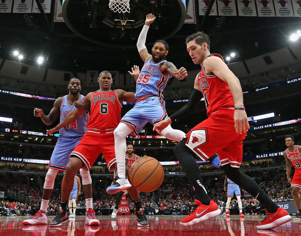 CHICAGO, ILLINOIS - MARCH 03: DeAndre' Bembry #95 of the Atlanta Hawks looses control of the ball between Cristiano Felicio #6 and Ryan Arcidiacono #51 of the Chicago Bulls at the United Center on March 03, 2019 in Chicago, Illinois. The Hawks defeated the Bulls 123-118. NOTE TO USER: User expressly acknowledges and agrees that, by downloading and or using this photograph, User is consenting to the terms and conditions of the Getty Images License Agreement. (Photo by Jonathan Daniel/Getty Images)