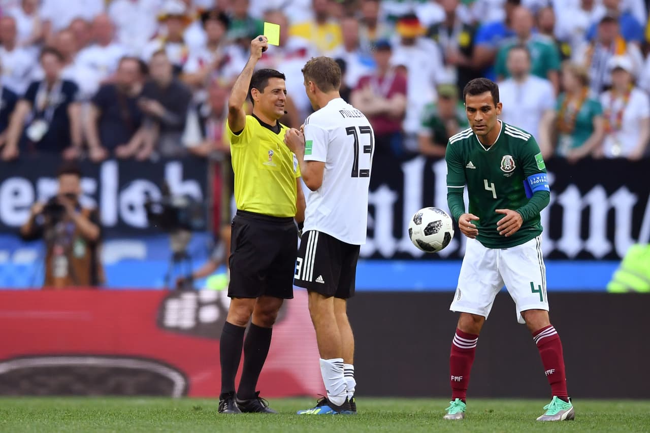MOSCOW, RUSSIA - JUNE 17: Thomas Mueller of Germany is shown a yellow card by Referee Cesar Ramos during the 2018 FIFA World Cup Russia group F match between Germany and Mexico at Luzhniki Stadium on June 17, 2018 in Moscow, Russia. (Photo by Hector Vivas/Getty Images)