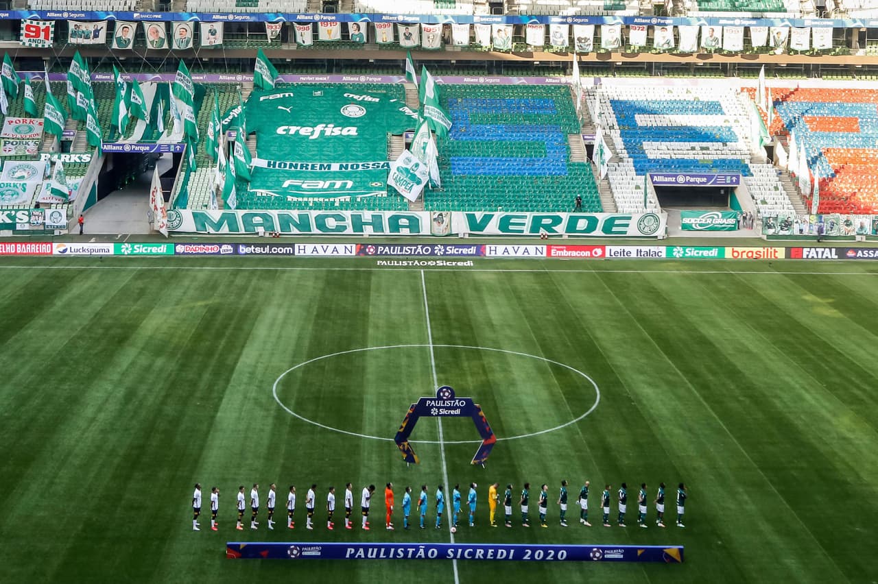 Palmeiras' and Corinthians' players during the national anthem before the Sao Paulo league final soccer match at Allianz Parque, Sao Paulo, Brazil, Saturday, Aug. 8, 2020. The match is being played without spectators to help curb the spread of COVID-19. (AP Photo/Carla Carniel)