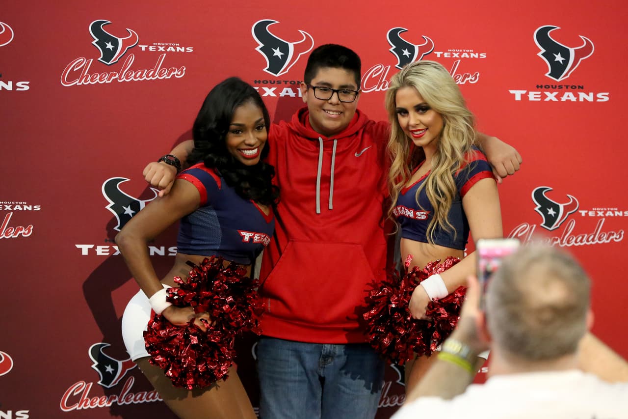 A fan poses with Houston Texans cheerleaders at the NFL Experience on Sunday, January 29, 2017 in Houston, TX. (AP Photo/Gregory Payan)