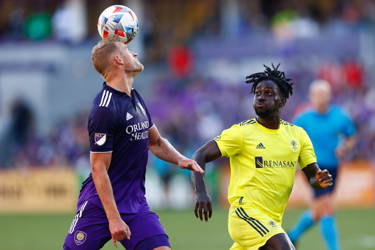 Oct 31, 2021; Orlando, Florida, USA; Orlando City defender Robin Jansson (6) clears the ball from Nashville SC forward C.J. Sapong (17) in the second half at Orlando City Stadium. Mandatory Credit: Nathan Ray Seebeck-USA TODAY Sports