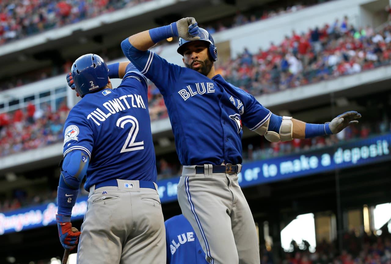 Toronto Blue Jays' Troy Tulowitzki (2) and Jose Bautista celebrate Bautista's three-run home run against the Texas Rangers during the ninth inning of Game 1 of baseball's American League Division Series, Thursday, Oct. 6, 2016, in Arlington, Texas. The Blue Jays won 10-1. (AP Photo/LM Otero)