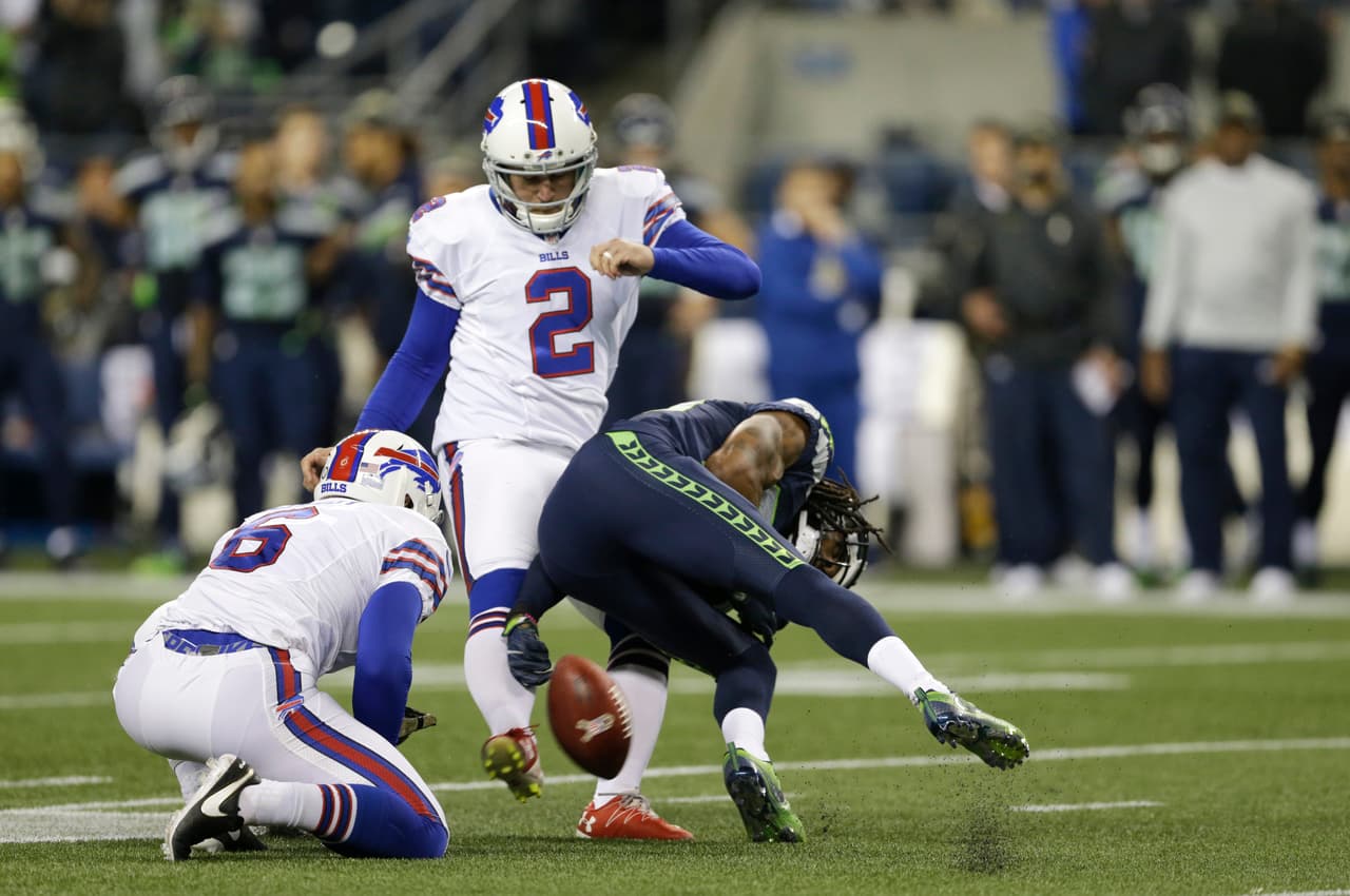 Seattle Seahawks cornerback Richard Sherman, right, reaches out to grab the ball on a failed field goal attempt by Buffalo Bills kicker Dan Carpenter (2) as Colton Schmidt holds in the first half of an NFL football game, Monday, Nov. 7, 2016, in Seattle. Sherman was given a defensive off-sides penalty on the play. (AP Photo/John Froschauer)