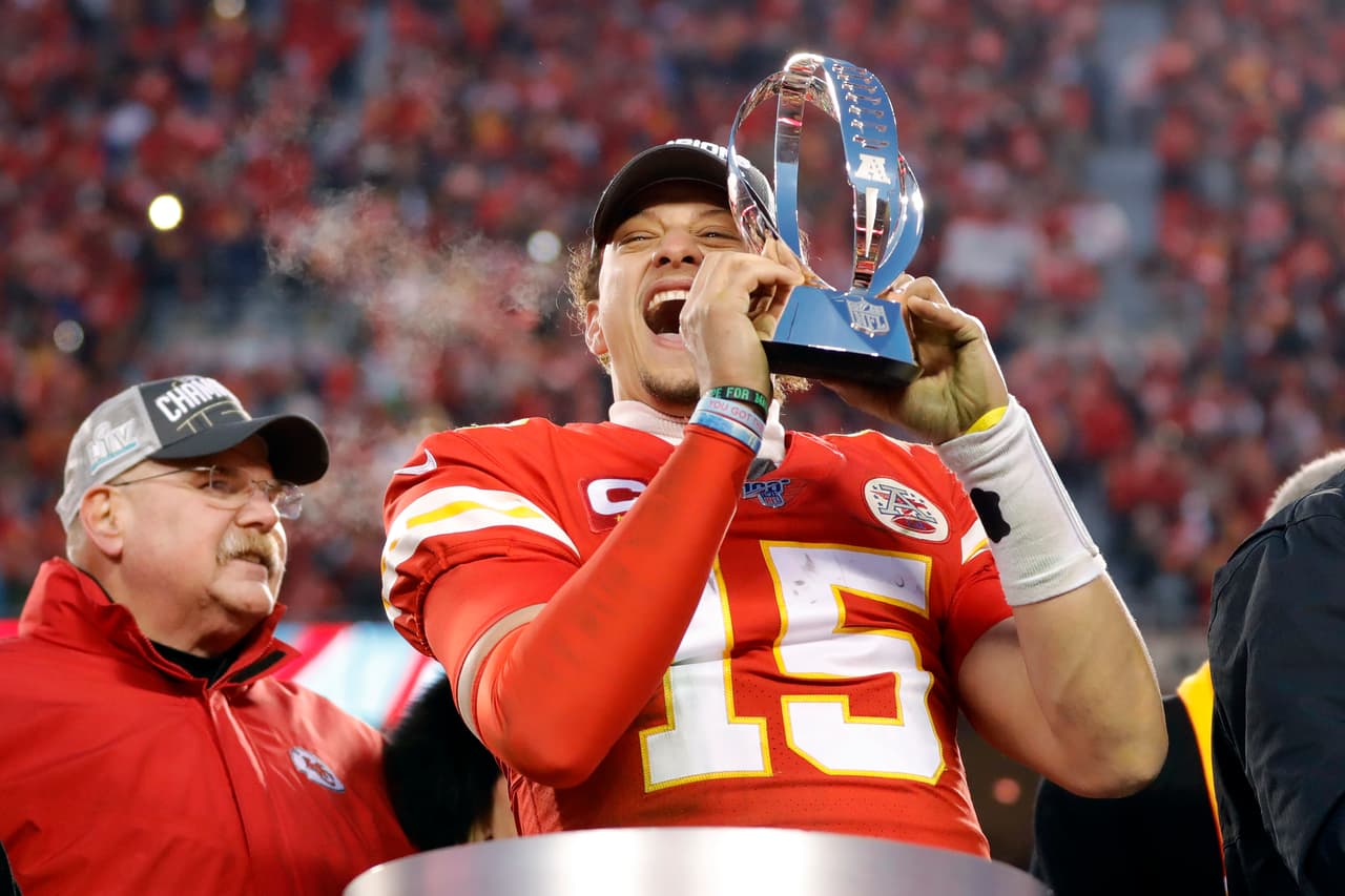 In this Jan. 19, 2020, photo, Kansas City Chiefs quarterback Patrick Mahomes holds the Lamar Hunt Trophy as he celebrates winning a NFL, AFC Championship football game against the Tennessee Titans in Kansas City, Mo. The most compelling dramas in the NFL this season unfolded on the field, not off of it. And any thought that the league was in jeopardy of losing its spot as America's favorite sport has been set on the back burner. (AP Photo/Colin E. Braley)