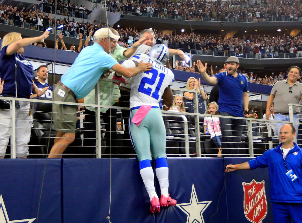 Dallas Cowboys running back Ezekiel Elliott (21) leaps into the end zone seating after scoring a touchdown on a long run in the second half of an NFL football game against the Cincinnati Bengals on Sunday, Oct. 9, 2016, in Arlington, Texas. (AP Photo/Ron Jenkins)