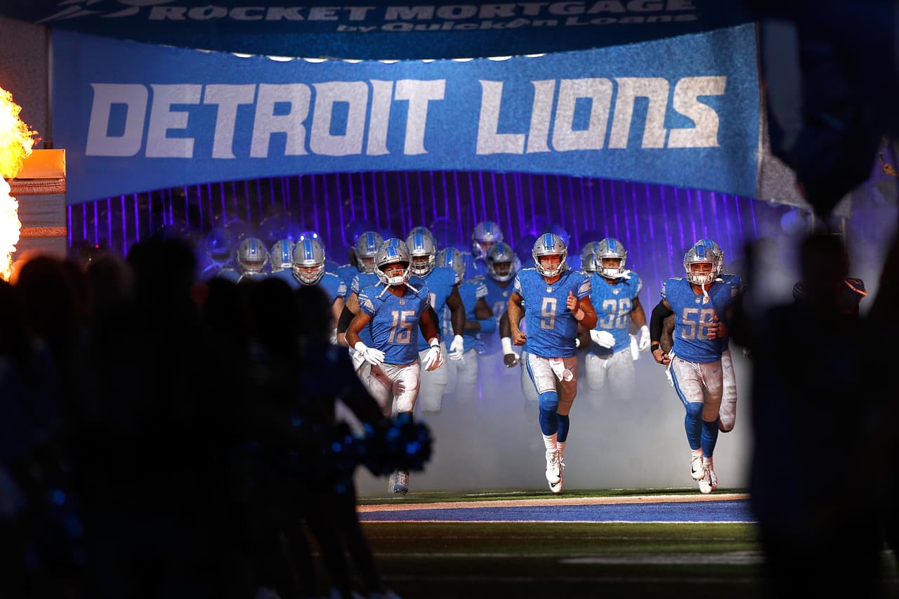 Detroit Lions quarterback Matthew Stafford (9), wide receiver Golden Tate (15) and linebacker Paul Worrilow (58) run as they lead team mates in introductions on the playing field from the tunnel during an NFL football game against the New England Patriots, Friday, Aug. 25, 2017, in Detroit. The Patriots won 30-28. (Scott Boehm via AP)