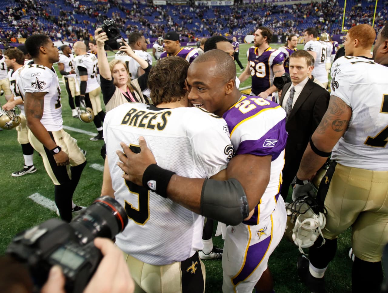 New Orleans Saints' Drew Brees talks to Minnesota Vikings' Adrian Peterson after an NFL football game Sunday, Dec. 18, 2011, in Minneapolis. (AP Photo/Charlie Neibergall)