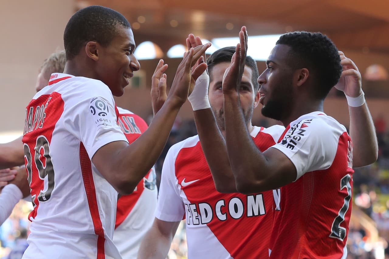 Monaco's French midfielder Thomas Lemar (R) celebrates after scoring a goal with Monaco's French forward Kylian Mbappe Lottin (L) during the French L1 football match Monaco (ASM) vs Toulouse (TFC) on April 29, 2017 at the "Louis II Stadium" in Monaco. / AFP PHOTO / VALERY HACHE (Photo credit should read VALERY HACHE/AFP/Getty Images)