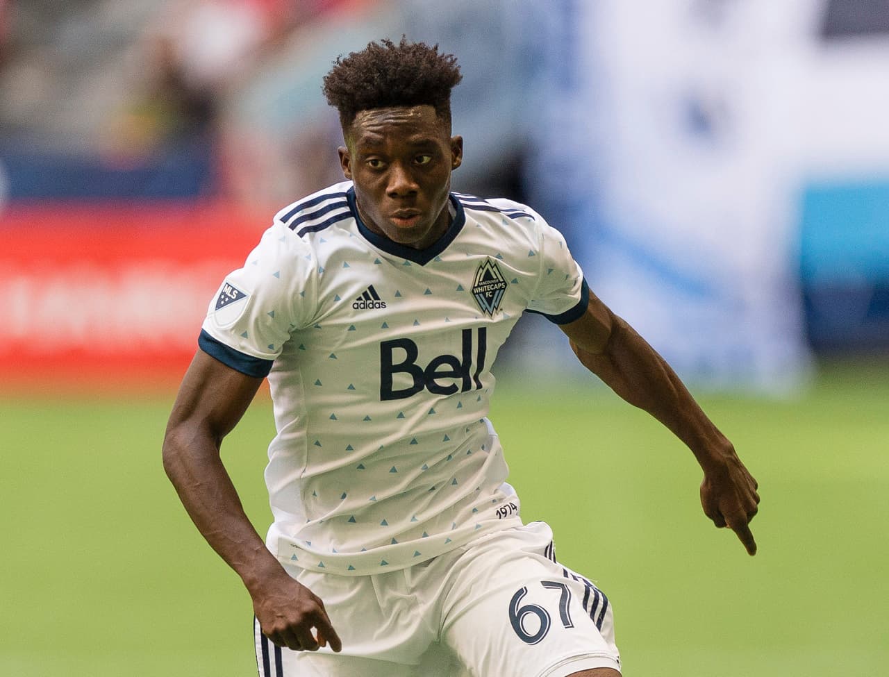 Jul 1, 2018; Vancouver, British Columbia, CAN; Vancouver Whitecaps forward Alphonso Davies (67) takes the ball up field during the second half against Colorado Rapids at BC Place. Colorado Rapids won 1-0. Mandatory Credit: Troy Wayrynen-USA TODAY Sports