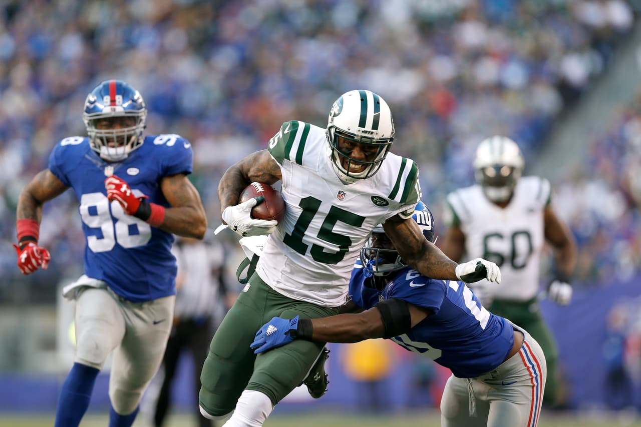 New York Jets wide receiver Brandon Marshall (15) runs the ball as New York Giants cornerback Prince Amukamara (20) defends during an NFL football game on Sunday, Dec. 6, 2015 in East Rutherford, N.J. The New York Jets won 23-20 in overtime. (Aaron M. Sprecher via AP)