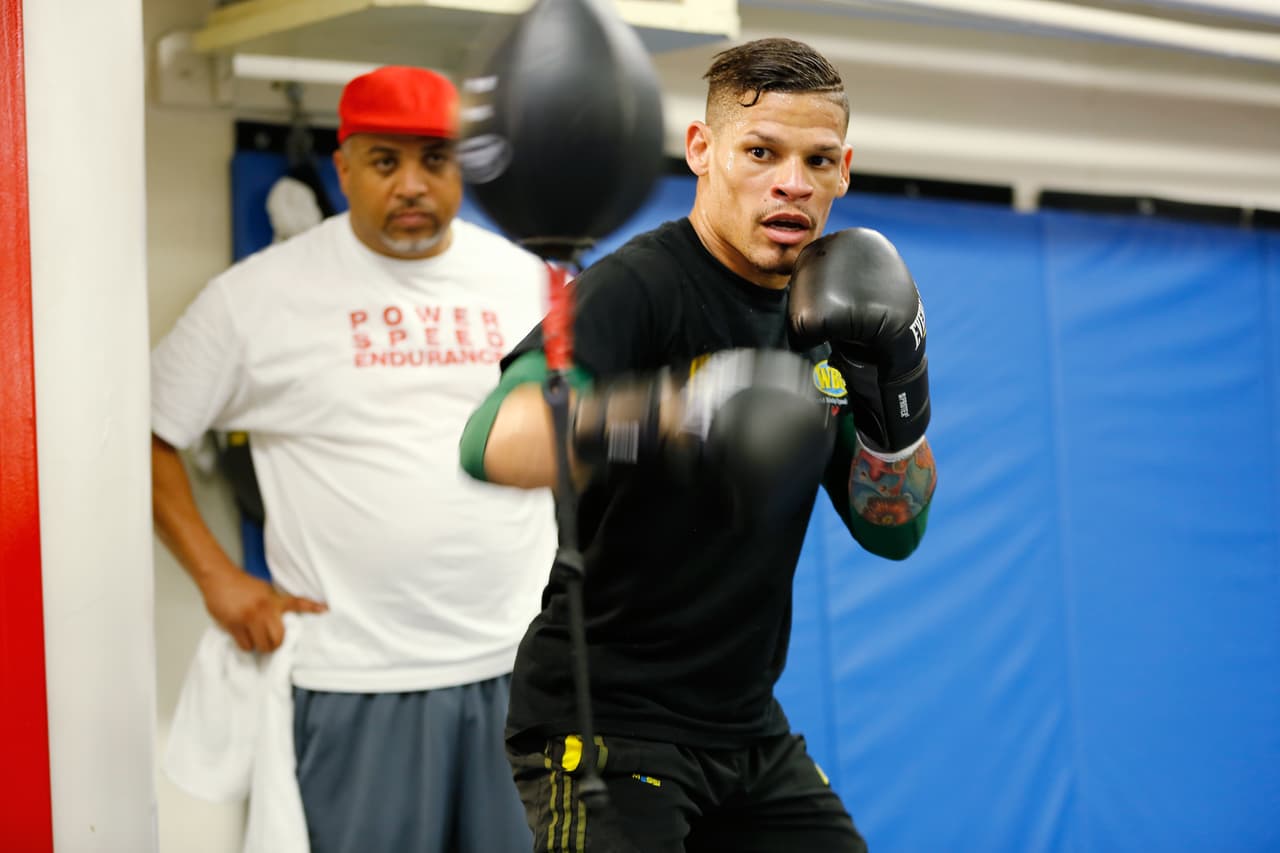 Boxer Orlando Cruz, right, is shown at an open workout at Mendez Boxing Gym, Tuesday, Sept. 24, 2013, New York. Cruz, the number one featherweight contender, is boxing's first openly gay fighter. (AP Photo/Nat Castaneda)