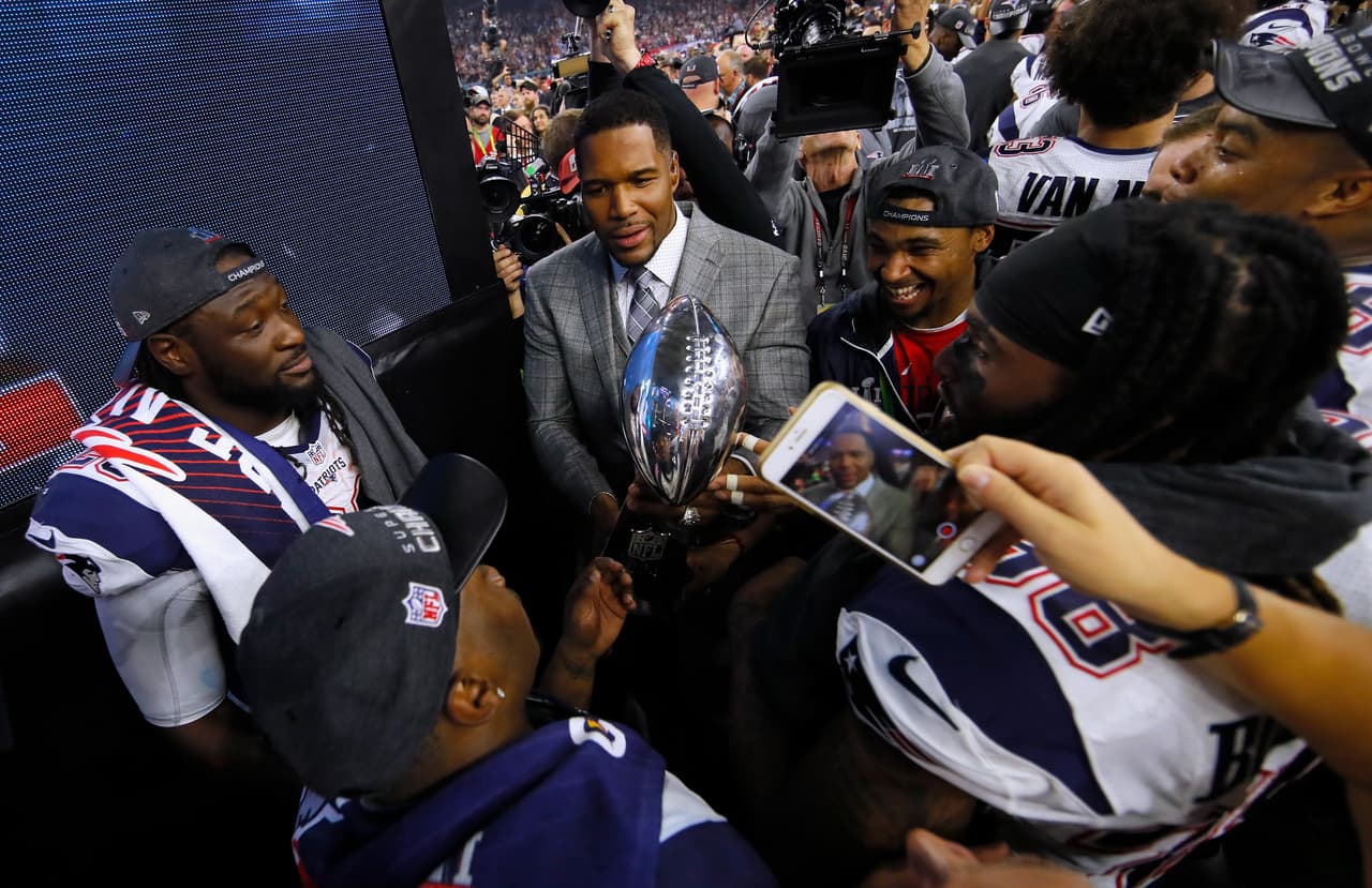 HOUSTON, TX - FEBRUARY 05: LeGarrette Blount #29 of the New England Patriots celebrates with the Vince Lombardi Trophy and Michael Strahan after defeating the Atlanta Falcons during Super Bowl 51 at NRG Stadium on February 5, 2017 in Houston, Texas. The Patriots defeated the Falcons 34-28. (Photo by Kevin C. Cox/Getty Images)