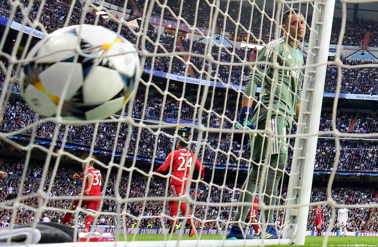 Bayern Munich's German midfielder Joshua Kimmich (L) celebrates scoring the opening goal during the UEFA Champions League semi-final second leg football match between Real Madrid and Bayern Munich at the Santiago Bernabeu Stadium in Madrid on May 1, 2018. (Photo by JAVIER SORIANO / AFP) (Photo credit should read JAVIER SORIANO/AFP/Getty Images)
