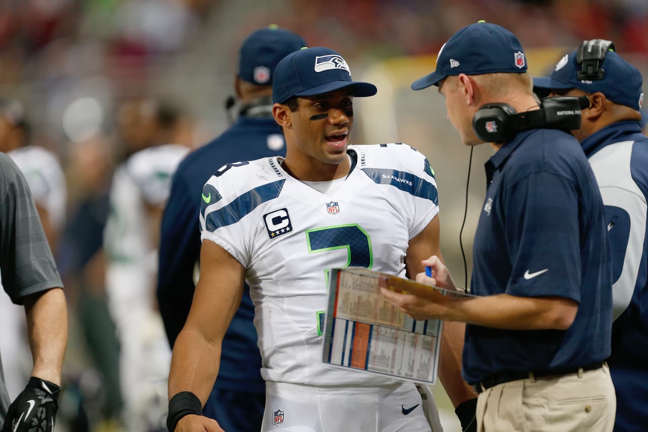 Seattle Seahawks quarterback Russell Wilson (3) talks with Offensive coordinator Darrell Bevell on the sidelines during a week 8 NFL game against the St. Louis Rams in St. Louis, Missouri on Monday, October 28, 2013. The Seahawks defeated the Rams 14-9. (AP Photo/Scott Boehm)