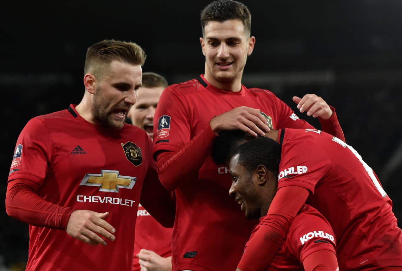 Manchester United's Odion Ighalo, front down, celebrates with teammates after scoring his side's second goal during the FA Cup fifth round soccer match between Derby County and Manchester United at Pride Park in Derby, England, Thursday, March 5, 2020. (AP Photo/Rui Vieira)