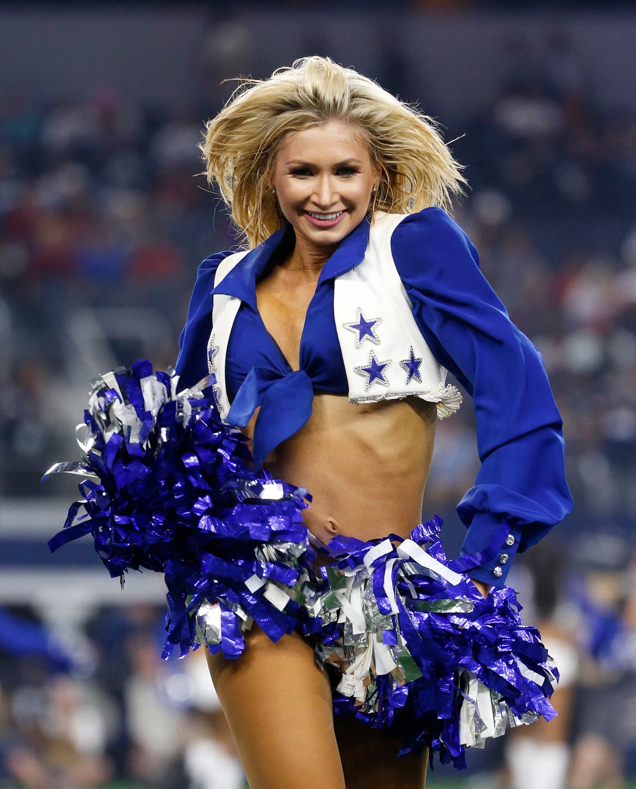 A Dallas Cowboys cheerleader performs during the second half of a preseason NFL football game against the Arizona Cardinals in Arlington, Texas, Sunday, Aug. 26, 2018. (AP Photo/Michael Ainsworth)