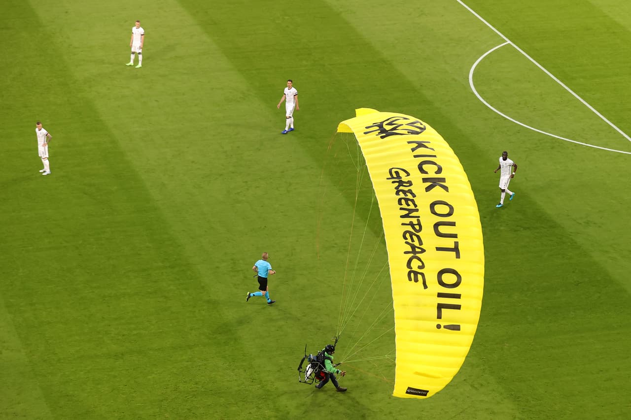 MUNICH, GERMANY - JUNE 15: A "Greenpeace" protester is seen flying into the stadium prior to the UEFA Euro 2020 Championship Group F match between France and Germany at Football Arena Munich on June 15, 2021 in Munich, Germany. (Photo by Alexander Hassenstein/Getty Images)