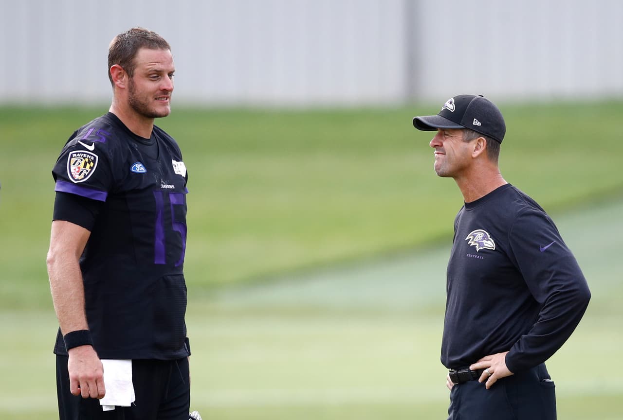 Baltimore Ravens quarterback Ryan Mallett, left, and head coach John Harbaugh talk during an NFL football training camp practice in Owings Mills, Md., Tuesday, Aug. 8, 2017. (AP Photo/Patrick Semansky)