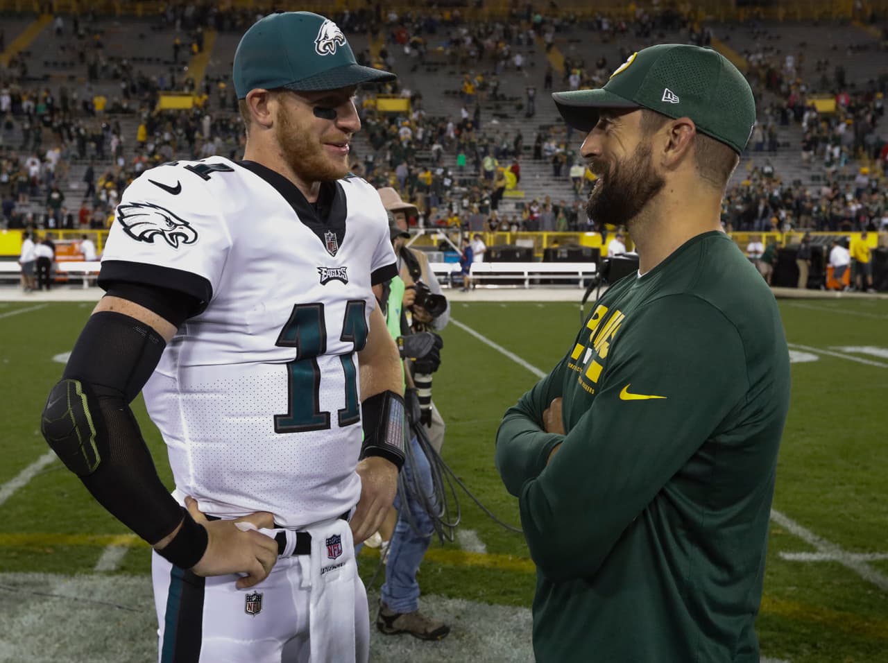 Philadelphia Eagles' Carson Wentz talks to Green Bay Packers' Aaron Rodgers after a preseason NFL football game Thursday, Aug. 10, 2017, in Green Bay, Wis. The Packers won 24-9. (AP Photo/Mike Roemer)