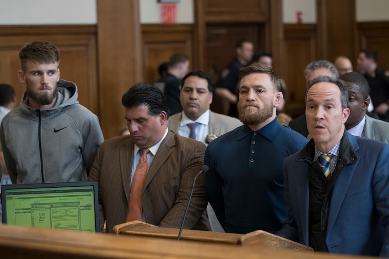 CORRECTS TO BROOKLYN CRIMINAL COURT, NOT BROOKLYN FEDERAL COURT-Ultimate fighting star Conor McGregor, foreground second right, is arraigned in Brooklyn Criminal Court, Friday, April 6, 2018 in New York. McGregor is facing criminal charges in the wake of a backstage melee he allegedly instigated that has forced the removal of three fights from UFC's biggest card of the year. Video footage appears to show the promotion's most bankable star throwing a hand truck at a bus full of fighters after a Thursday news conference for UFC 223 at Brooklyn's Barclays Center. (AP Photo/Mary Altaffer, Pool)